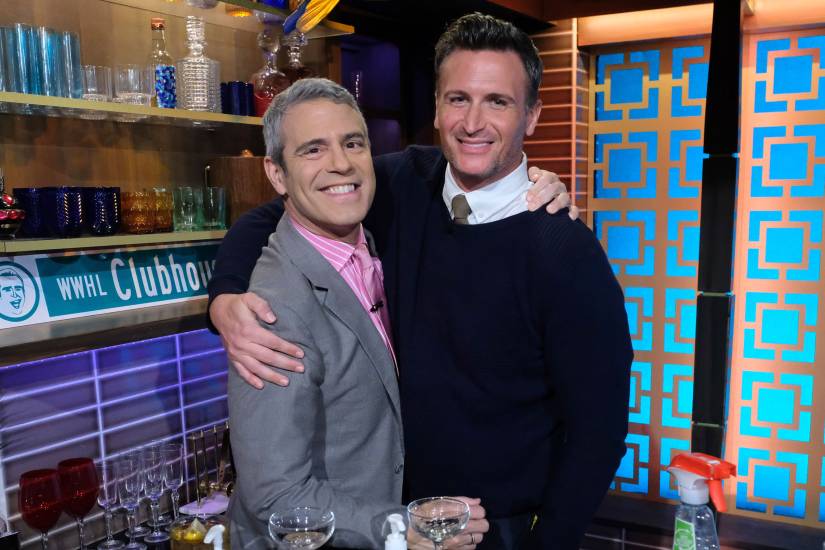 Andy Cohen smiling with his past partner, John Hill
